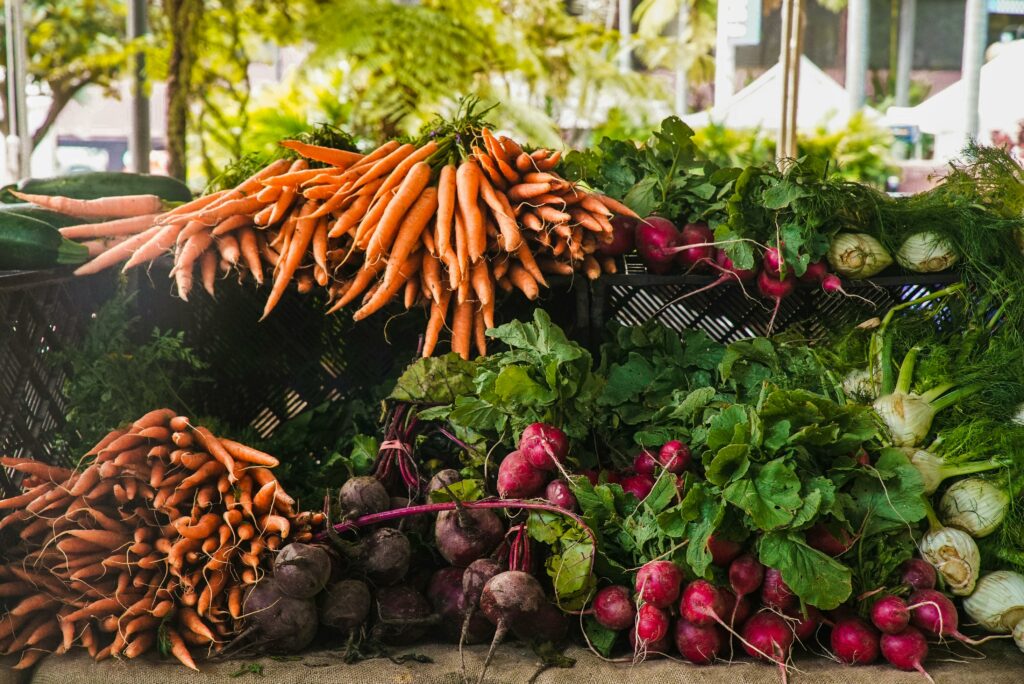 pexels photo 1656663 1656663 A vibrant display of fresh carrots, radishes, and greens at a local outdoor market.